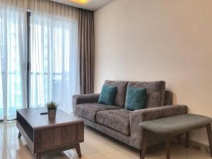 a living room with a couch and a coffee table at R&F Princess Cove 2BR, JB CIQ, Shopping Malls, by Good Life Homestay in Johor Bahru +10 photos