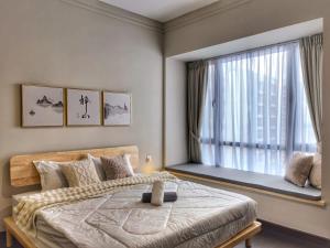 a bedroom with a bed and a large window at R&F Princess Cove 3BR, Sea View, JB CIQ, by Good Life Homestay in Johor Bahru +35 photos