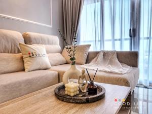 a living room with a couch and a coffee table at R&F Princess Cove 2, 3BR, Sea View, JB CIQ, by Good Life Homestay in Johor Bahru