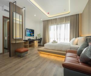 a bedroom with a bed and a couch and a television at BBQ Hotel with Swimming Pool in Lạng Sơn in Lạng Sơn