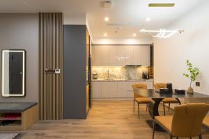 a kitchen and dining room with a table and chairs at BBQ Hotel with Swimming Pool in Lạng Sơn in Lạng Sơn