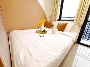 a bedroom with a white bed with a window at Casita Aroha SHORE 2 B02-19114 in Sampong