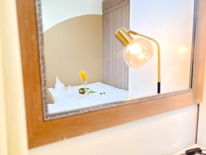 a mirror on a wall with a table with a lamp at Casita Aroha SHORE 2 B02-19114 in Sampong +41 photos