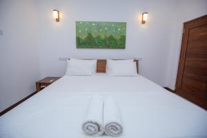 a bedroom with a white bed with two towels on it at Villa D8 in Mirissa +69 photos