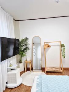 a bedroom with a large mirror and a bed at MISO Stay in Seoul