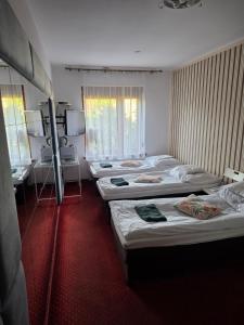 a room with four beds in it with a desk at Villa Ventana Poznań City Free Parking Śniadanie w Cenie in Poznań