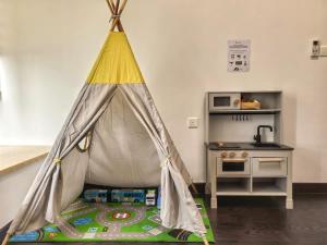 a teepee tent in a room with a kitchen at R&F Princess Cove 2BR Sea View Family Friendly in Johor Bahru