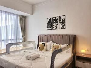 a bedroom with a large white bed with a window at R&F Princess Cove 2BR Sea View Family Friendly in Johor Bahru +17 photos