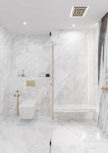 a white bathroom with a shower and a toilet at Westminster Dubai Mall in Dubai +168 photos