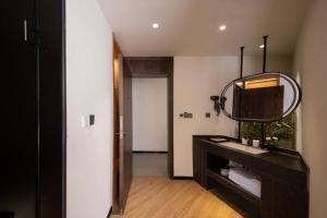 a bathroom with a black vanity and a mirror at Yunlanli Mountainside Homestay in Shangri-La