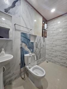 a bathroom with a toilet and a sink at Surf Trip Maldives in Thulusdhoo +27 photos
