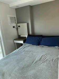 Ένα ή περισσότερα κρεβάτια σε δωμάτιο στο Aayah Staycation condo & Hotel