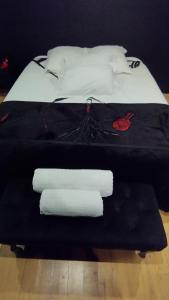 a bed with two white towels on top of it at La Maison Coquine in Béthune +19 photos