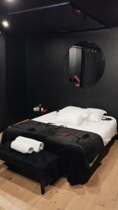 a bedroom with a large bed with a mirror on the wall at La Maison Coquine in Béthune