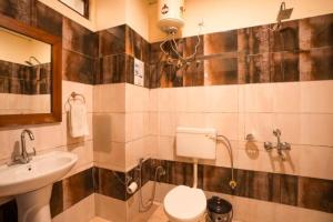 a bathroom with a toilet and a sink at goSTOPS Mussoorie, Library Road in Mussoorie +49 photos