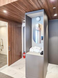 a bathroom with a vanity with a mirror at Paramion Hotel in Busan