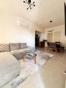 a living room with a couch and a table at Blue Sea Vallarta - Relax, Explore and Enjoy! in Los Algodones