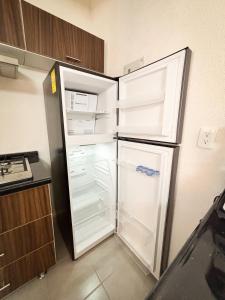 a refrigerator with its door open in a kitchen at Blue Sea Vallarta - Relax, Explore and Enjoy! in Los Algodones