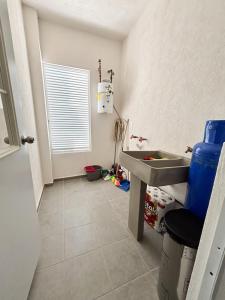 a bathroom with a sink and a tiled floor at Blue Sea Vallarta - Relax, Explore and Enjoy! in Los Algodones