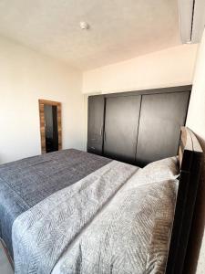 a bedroom with a large bed with a black headboard at Blue Sea Vallarta - Relax, Explore and Enjoy! in Los Algodones +9 photos