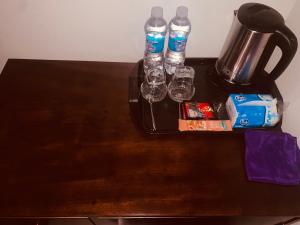 a table with two water bottles and glasses on it at Châu Home in Ninh Binh