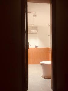 a bathroom with a toilet and a tub at Châu Home in Ninh Binh