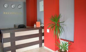 an office with a reception desk with a palm plant at Maribel Spa Hotel in Koprivlen