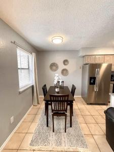 a dining room with a table and a refrigerator at 1BD Condo HWY161-183 DFW South Irving - I67 in Sowers