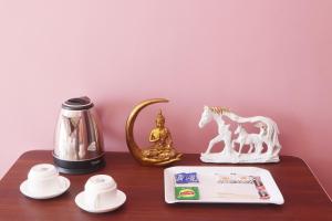a table with a figurine of a horse on it at Serene Vista Dharamshala in Dharmsāla