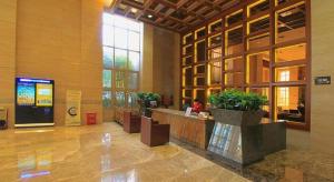 a lobby with a reception desk in a building at Zhangjiagang Jiangnan Garden Hotel in Xiwujieqiao