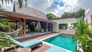 a swimming pool in the backyard of a house at Villa Madah - Secluded & Romantic Retreat 1BR Near Umalas with Private Pool & View in Kerobokan