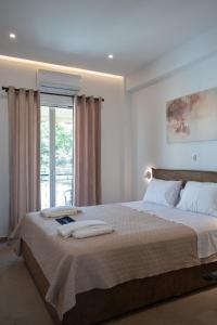 Postel nebo postele na pokoji v ubytování Filoxenia MG Projects Sereno 2 Apartment