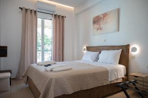 Postel nebo postele na pokoji v ubytování Filoxenia MG Projects Sereno 2 Apartment