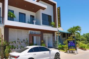 a white car parked in front of a building at River Hotel 5 in Long Xuyên