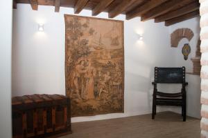 a tapestry hanging on a wall in a room at Casa de la Panadería in Los Navalucillos