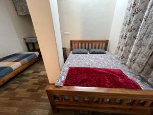 a bedroom with two beds in a room at Chasumi Homestay in Darjeeling