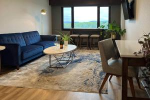 a living room with a blue couch and a table at Radisson Hotel La Crosse in La Crosse