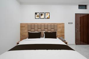 バラナシにあるSuper Collection O Banaras Railway Junction Formerly Varanasi Suitesのベッドルーム(白い大型ベッド、黒い枕付) +19枚の写真