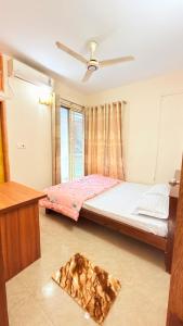 a bedroom with a bed and a ceiling fan at Azul-Fully Furnished Modern Apartment in Bāiljuri