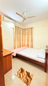 a bedroom with a bed and a pizza on the floor at Azul-Fully Furnished Modern Apartment in Bāiljuri +1 photo