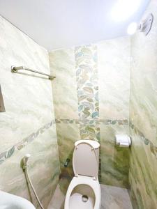 a bathroom with a toilet and a shower at Azul-Fully Furnished Modern Apartment in Bāiljuri