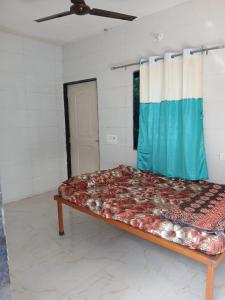 a large bed in a room with a window at Sahil Bed and Breakfast in Alibag