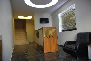 a waiting room with a chair and a clock on the wall at Deveci Hotel in Mut