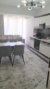 a kitchen with a table and chairs in a room at AIRPORT/PARKING/VINIETA.MD in Chişinău