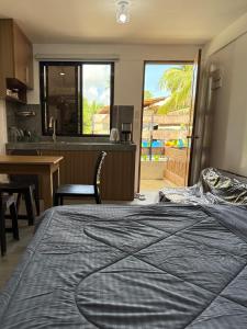 ein Schlafzimmer mit großem Bett und eine Küche in der Unterkunft Amakan Malinao Apartments for long term rentals only in General Luna + 9 Fotos