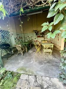 a patio with chairs and tables in front of a building at les chaussons d'arlequine in Dompierre-sur-Besbre