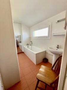 a bathroom with a tub and a sink at les chaussons d'arlequine in Dompierre-sur-Besbre +2 photos