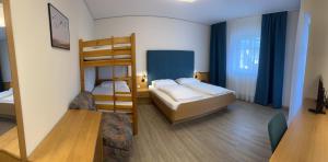 a room with two bunk beds and a table at Radhotel Schischek in Oberpurkla