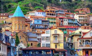 a group of buildings on a hill with a tower at Apartment Khizana in Tbilisi City