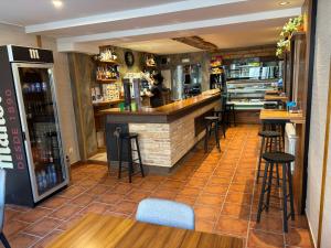 a bar in a restaurant with stools at La Cachava in Castrojeriz